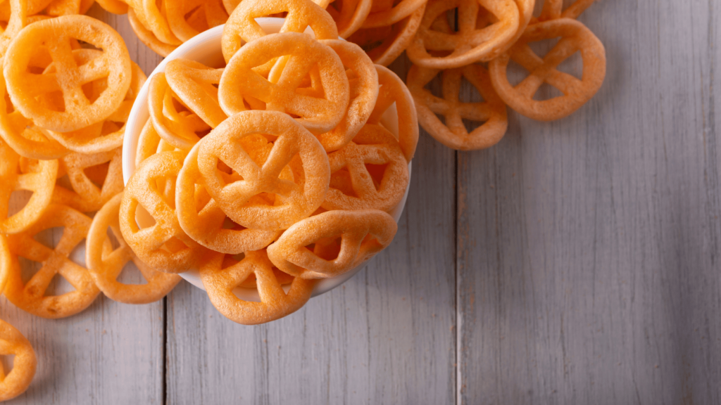 Fried Mexican wheel chips in a bowl on a wood table.